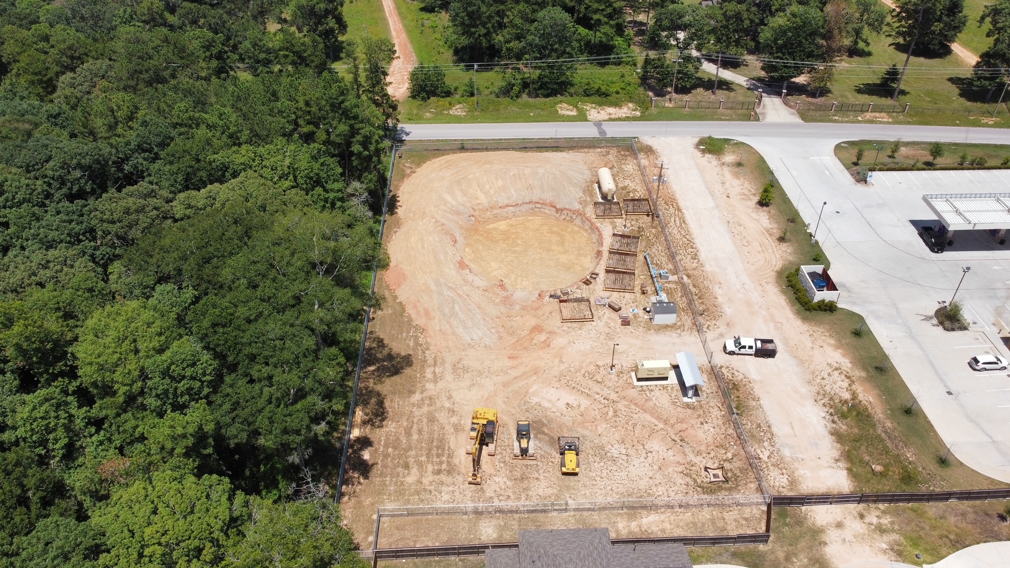 Drone view of a deep circular excavation with reinforcing forms arranged along the work area